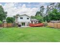 Expansive backyard with lush lawn, a wooden fence, and a spacious deck perfect for outdoor entertaining at 281 Lakeshore Ne Dr, Marietta, GA 30067