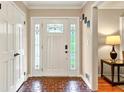 Inviting foyer featuring brick flooring and a decorative glass front door with sidelights at 281 Lakeshore Ne Dr, Marietta, GA 30067