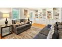 Comfortable living room with hardwood floors, built-in bookshelves, and large windows at 281 Lakeshore Ne Dr, Marietta, GA 30067