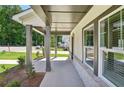 Inviting covered porch with sturdy columns and views of the landscaped yard at 5120 Kongoni Ct, Cumming, GA 30041