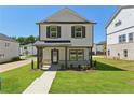 Beautiful two-story home with a covered porch and lush green lawn at 5120 Kongoni Ct, Cumming, GA 30041