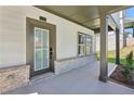 Welcoming front entrance featuring stylish door and covered porch with stone accents at 5120 Kongoni Ct, Cumming, GA 30041