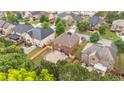 Aerial view of a brick house with a patio in a neighborhood with mature trees at 8744 Hamil Ct, Douglasville, GA 30135