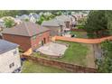 Private backyard featuring a paver patio with retaining wall and a wood fence at 8744 Hamil Ct, Douglasville, GA 30135