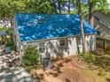 Back exterior view showing the metal roof, patio set, and brick at 1844 Stanton St, Decatur, GA 30032