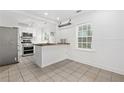Bright kitchen featuring stainless steel appliances, white cabinets, and butcher block countertop at 1844 Stanton St, Decatur, GA 30032