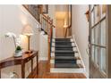 Elegant foyer with hardwood floors, staircase with iron spindles, and a stylish console table at 2025 Eagle Rdg, Roswell, GA 30076