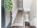 Bright foyer showcasing stairs, white wainscoting, and wood floors for a welcoming entrance at 3386 Vintage Se Cir # 8, Smyrna, GA 30080