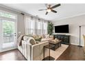 Cozy living room with a large sectional sofa, ceiling fan, and lots of natural light at 3386 Vintage Se Cir # 8, Smyrna, GA 30080