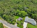 An aerial view of a home backing to expansive woods, with a winding two lane road at 905 John Ward Rd, Marietta, GA 30064