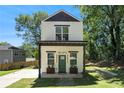 Inviting two-story home with a well-maintained lawn and a charming entrance at 1473 Lansing Se St, Atlanta, GA 30315