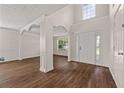 Bright living room showcasing hardwood floors, decorative columns, and vaulted ceiling at 211 Millstone Dr, Hampton, GA 30228
