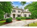 Charming brick home featuring dark shutters, manicured landscaping, and brick-paved driveway at 2115 Howell Mill Nw Rd, Atlanta, GA 30318