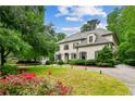 Elegant brick home with manicured lawn, mature trees and private drive offers great curb appeal at 2115 Howell Mill Nw Rd, Atlanta, GA 30318