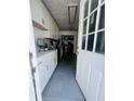 Galley kitchen featuring white cabinets, grey tile flooring, stainless steel appliances and laundry area at 4312 Idlewood Ln, Tucker, GA 30084
