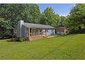 Inviting single-story home with a well-maintained lawn, showcasing a spacious yard and ample natural light at 4070 Feather Dr, Douglasville, GA 30135