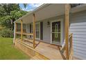 Cozy front porch with wooden railings and a decorative welcome mat, creating a warm and inviting entrance at 4070 Feather Dr, Douglasville, GA 30135