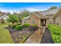 Charming single-story home featuring manicured front lawn and stone-accented entrance with tasteful landscaping at 7030 Mandevilla Ln, Douglasville, GA 30135