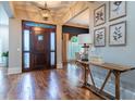 Elegant foyer boasts hardwood floors, a statement door, and designer touches setting a welcoming tone at 799 Wagon Trl, Woodstock, GA 30188