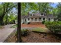 Charming home featuring a welcoming front porch and wooded lot at 1104 Warrenhall Ne Ln, Brookhaven, GA 30319