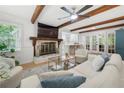 Bright living room featuring a fireplace, ceiling beams and hardwood floors at 1104 Warrenhall Ne Ln, Brookhaven, GA 30319