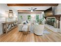 Spacious living room featuring hardwood floors, a fireplace, and an abundance of natural light at 1104 Warrenhall Ne Ln, Brookhaven, GA 30319