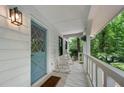 Inviting front porch with blue door and rocking chairs at 1104 Warrenhall Ne Ln, Brookhaven, GA 30319
