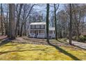 Inviting home with a classic facade and covered porch, nestled in a peaceful, tree-lined neighborhood setting at 3271 Sutcliffe Nw Rdg, Marietta, GA 30064