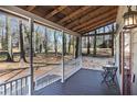 Cozy covered front porch featuring a bistro table set perfect for enjoying the tranquil, wooded surroundings at 3271 Sutcliffe Nw Rdg, Marietta, GA 30064