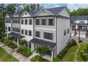 Attractive townhome showcasing three-story layout, tidy landscaping, and stylish gray siding at 429 Stovall Pl, Woodstock, GA 30188
