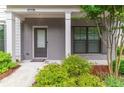 Inviting front porch featuring painted brick, craftsman columns, and beautiful landscaping at 429 Stovall Pl, Woodstock, GA 30188