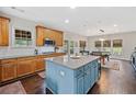 Open kitchen with an island, wooden cabinets, and stainless steel appliances at 514 Augusta Dr, Canton, GA 30115