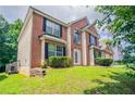 Attractive two-story brick home featuring a well-kept lawn and tasteful landscaping at 7190 Cavender Sw Dr, Atlanta, GA 30331