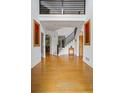 Grand foyer featuring hardwood floors, high ceilings, and an elegant staircase with metal railings at 2700 Still Farms Ct, Lawrenceville, GA 30043