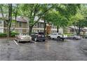 A residential apartment complex boasts convenient parking spaces nestled under a canopy of lush trees at 5157 Roswell Rd # 1, Atlanta, GA 30342