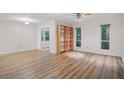 Bright living room with hardwood floors, white walls, a ceiling fan, and an open bookshelf at 5157 Roswell Rd # 1, Atlanta, GA 30342