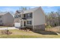 Inviting two-story home with modern architecture and lush landscaping at 620 Lobelia Way, Locust Grove, GA 30248