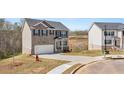 Attractive two-story home with a two-car garage and a well-kept front yard at 620 Lobelia Way, Locust Grove, GA 30248