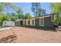 Beautifully renovated home with a dark brick exterior, bright trim, and a well-manicured front yard at 3350 Pine Meadow Nw Rd, Atlanta, GA 30327
