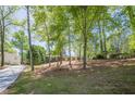Brick home nestled among mature trees, offering a sense of privacy and tranquility at 3350 Pine Meadow Nw Rd, Atlanta, GA 30327