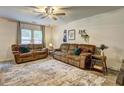 Comfortable living room with neutral walls, ceiling fan, area rug, and lots of comfortable seating at 336 Freeman Cir, Villa Rica, GA 30180