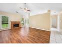 Spacious living room featuring hardwood floors, a brick fireplace, and natural light from the windows at 467 Ravinia Way, Lawrenceville, GA 30044