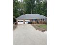 Brick house with attached two-car garage and a concrete driveway at 2166 Lake Ridge Ter, Lawrenceville, GA 30043