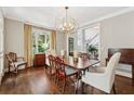 Formal dining room with wood floors, modern chandelier and traditional furnishings at 4750 Freeport Bay Ne, Roswell, GA 30075