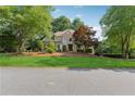 Suburban home with a manicured lawn, mature trees, and a stone-and-siding facade at 4750 Freeport Bay Ne, Roswell, GA 30075