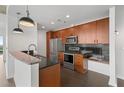 Modern kitchen with stainless steel appliances, granite countertops, and dark wood cabinetry at 943 Peachtree Ne St # 1518, Atlanta, GA 30309