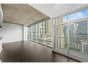 Bright living room with floor-to-ceiling windows and balcony access offering a beautiful city view at 943 Peachtree Ne St # 1518, Atlanta, GA 30309