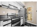 Well-equipped kitchen with stainless steel appliances, sleek black countertops, and tiled flooring at 1 Biscayne Nw Dr # 804, Atlanta, GA 30309
