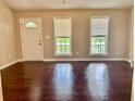 Inviting living room with wood floors and natural light from two large windows at 186 Grapevine Dr, Douglasville, GA 30134