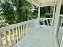 Covered white porch provides a relaxing outdoor space with views of the surrounding lush greenery at 186 Grapevine Dr, Douglasville, GA 30134